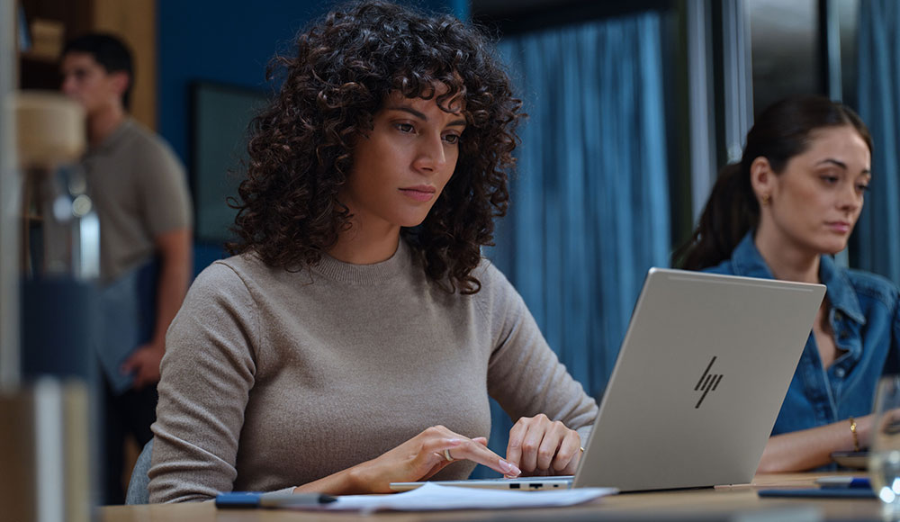 HP EliteBook 6 G2q laptop in use on a desk, highlighting its slim design and enterprise-focused build