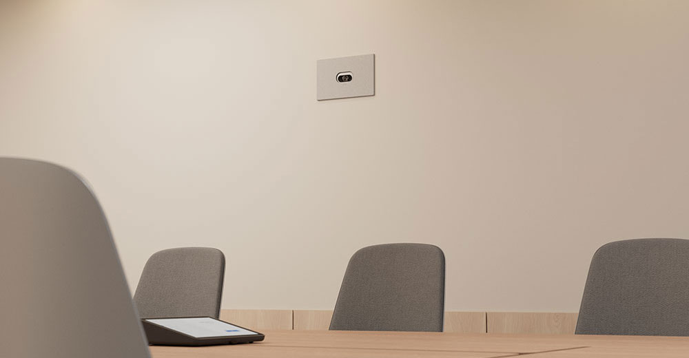 Logitech Rally AI camera recessed into a conference room wall for low-profile installation